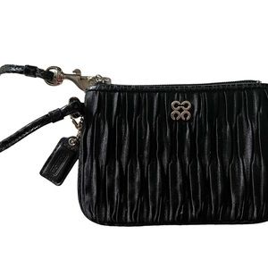 Coach small wristlet.  Black fabric with corner zip closure.  Silver hardware.
